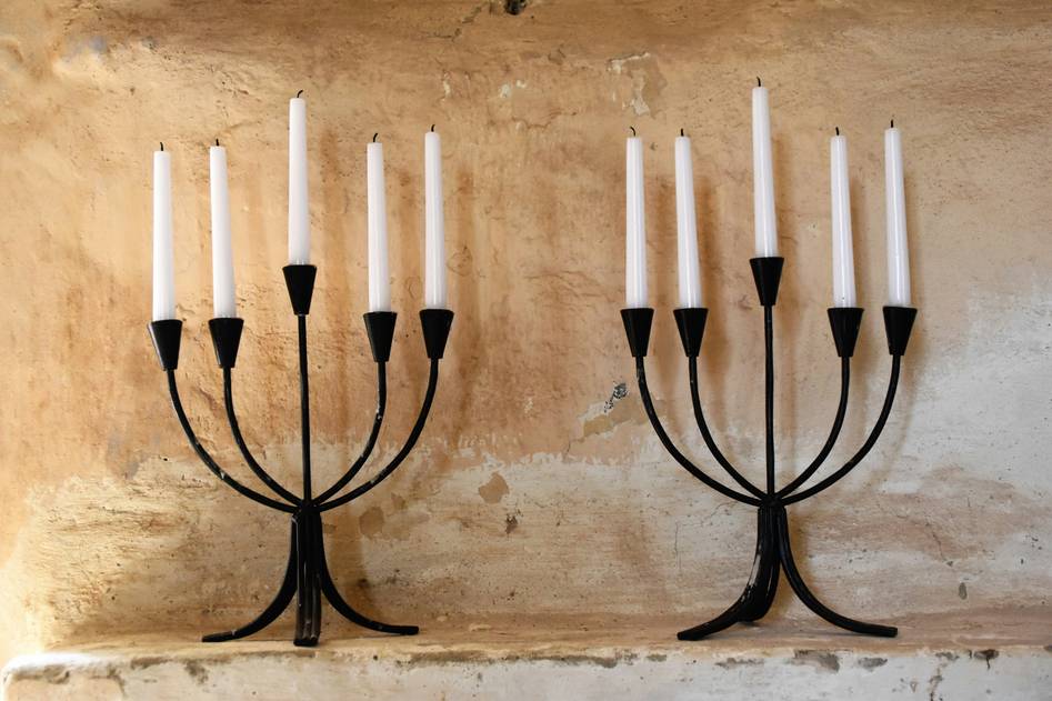 Collection of modern and vintage candle holders arranged on a neutral tabletop
